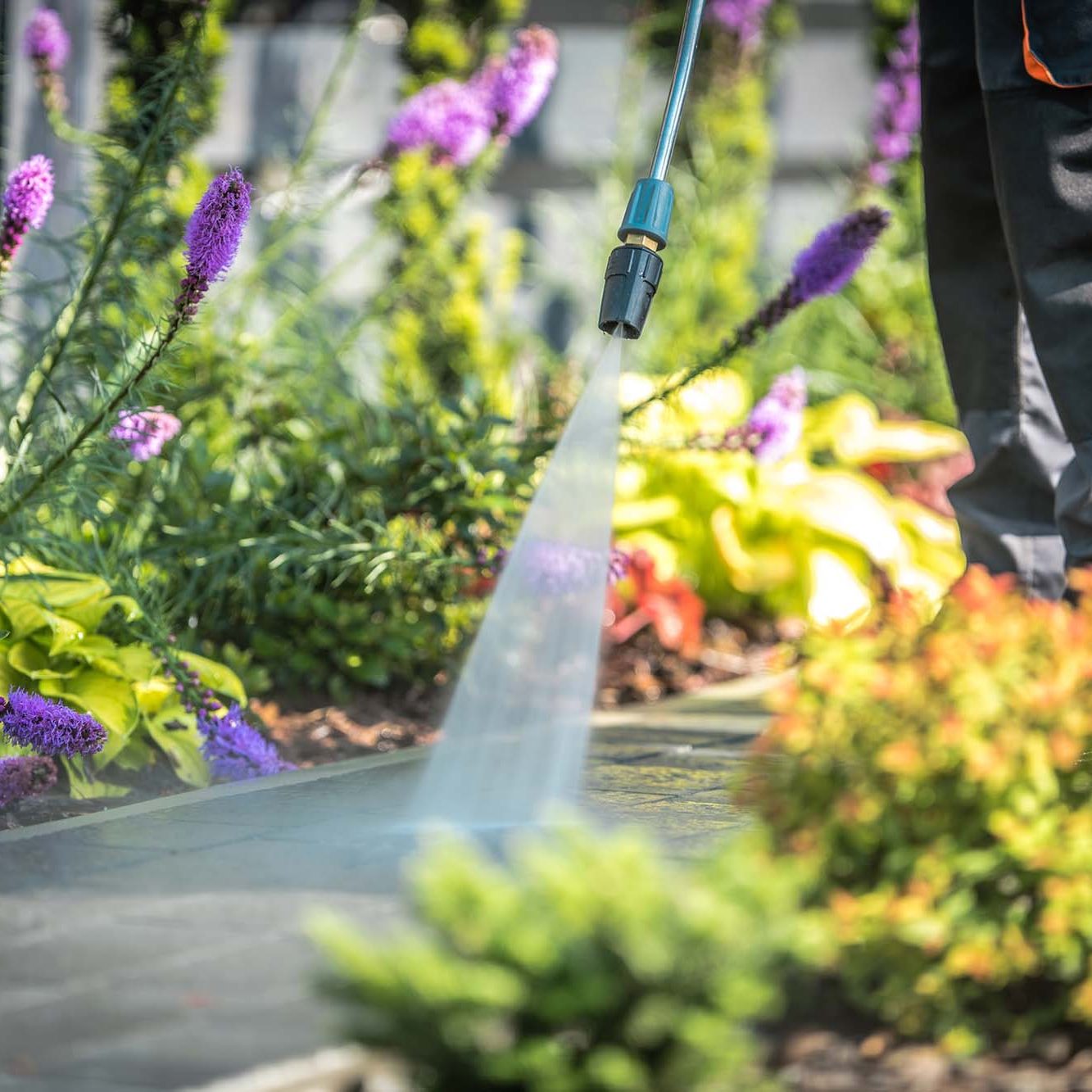 Power Washing Garden Cobble Stone Paths. Outdoor Cleaning Using Pressure Washer. Closeup Photo.